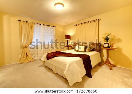 Elegant bedroom with light yellow walls and matched bedroom cloth set