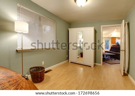 Small office room with hardwood floor and olive walls