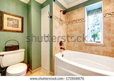 Olive and mocha tones bathroom with rustic picture and towel basket Olive and mocha tones bathroom with rustic picture and towel basket