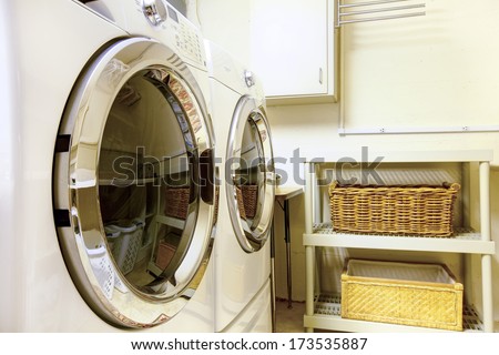 Old style laundry room with modern appliances and wicker baskets