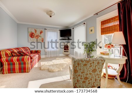 Light Blue Family Room With Comfortable Red Sofa, Floral Chair, Wooden White Table And White Soft Bear Rug