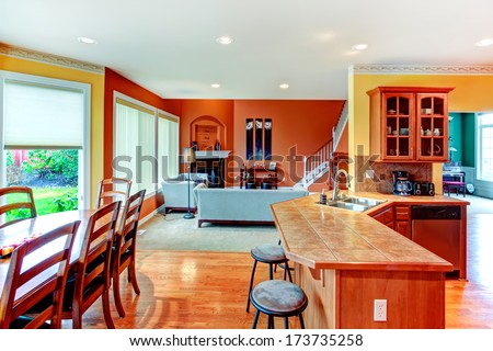 Interior Design For Kitchen, Dining And Living Room Combination. Yellow Walls Of Kitchen And Dining Room Match Well With Orange Color Of Living Room