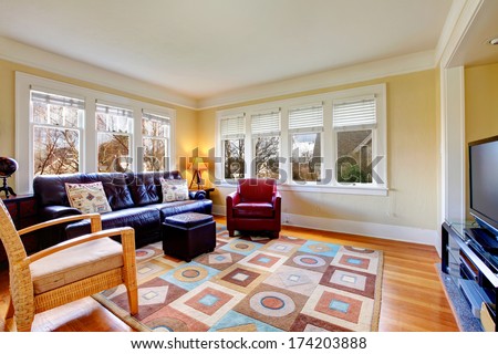 Living room with light color wall and ceiling, hardwood floor and leather furniture set