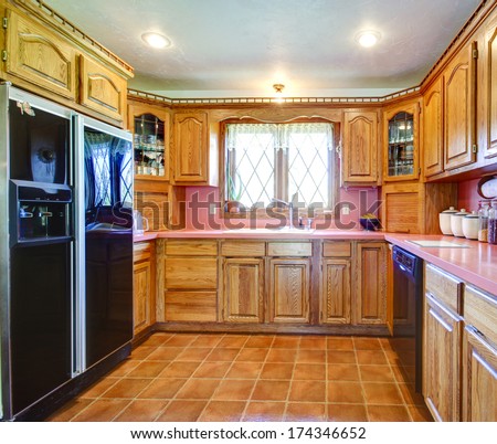 Tile Floor Kitchen Room With Black Refrigerator, Decorated Wood Cabinets