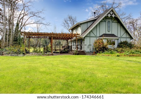Designed rustic farmhouse with open front deck and attached wood pergola