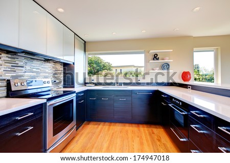 Elegant Kitchen Room With Black Wood Storage Combination With Stoned Backsplash And Decorative Vase And Wall Shelf