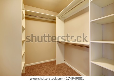 Ivory And Beige Walk-In Closet With Carpet Floor