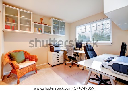 Furnished  office room with rustic wicker chair, glass door storage cabinets on the wall
