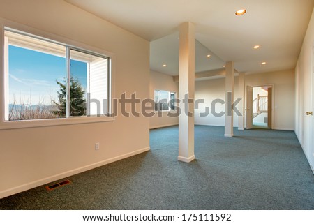 Light tones big empty room with windows, carpet floor and colomns