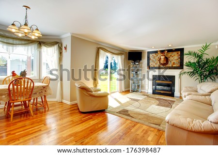 Cozy Living Room With Fireplace And Elk Head On The Wall, Soft Rug And Comfortable Couch With Chairs. Living Room Extended To Dining Area