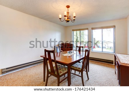 Bright dining room with antique furniture, beige carpet floor