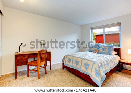 Bright bedroom for young adult with soft carpet floor and rustic desk with chair