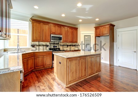 Bright Kitchen Room With Wooden Storage, Tile Floor. Tile Decorated Back Splash.