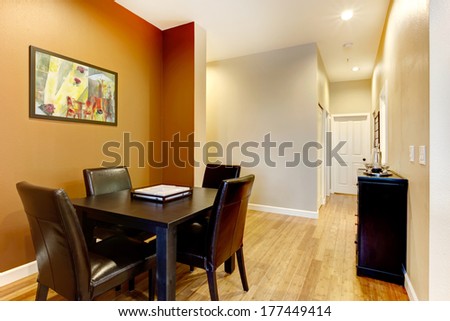 Open wall design idea for small dining area. Furnished with black dining table set and cabinet.