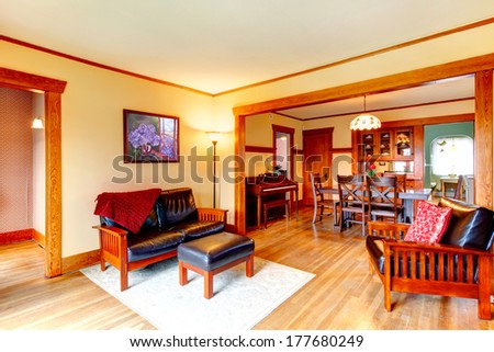Ivory Cozy Living Room With Leather Couch, Chair, Rug. Open Wall Design With Dining Room