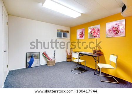 White and yellow art room without window. Blue carpet floor