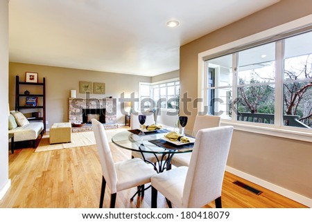 Open design for living and dining room interior. View of the served dining table and living room