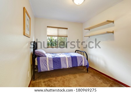 Light walls rectangle bedroom with brown carpet floor and old black metal frame bed
