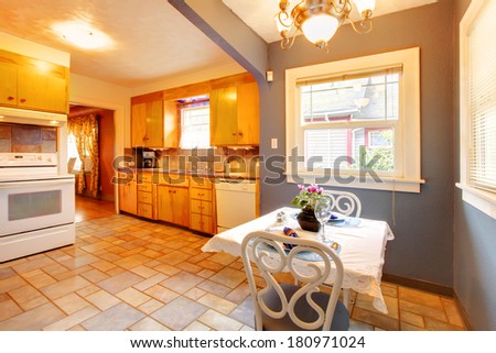 Gold kitchen room with light blue dining area