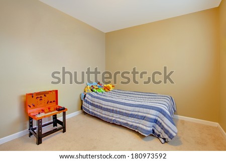 Very simple boys empty bedroom with a single bed