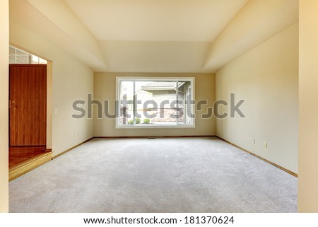 Empty room with window, carpet floor. Ivory walls blend with white window