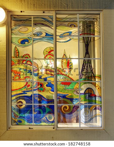 Colorful abstract painting of Seattle in bright glass paints on the window. Stained glass mural.