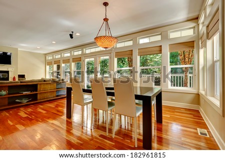 Spacious living room with walkout deck. View of elegant white and black dining table set