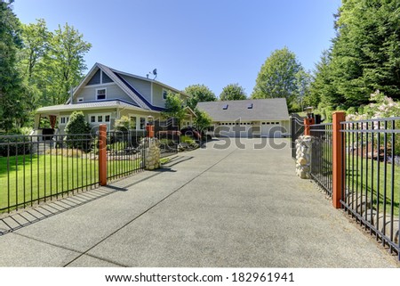 View of open entrance iron gates and driveway.