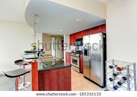 Bright burgundy kitchen room with bar and wine rack