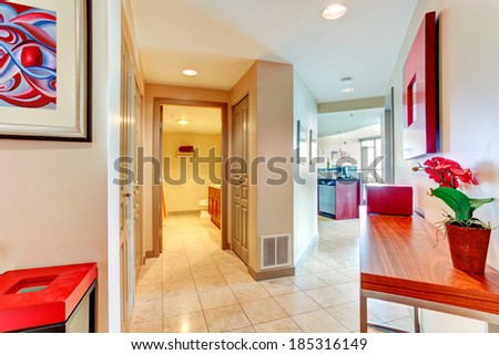 Hallway in modern apartment. View of open door to bathroom and living room