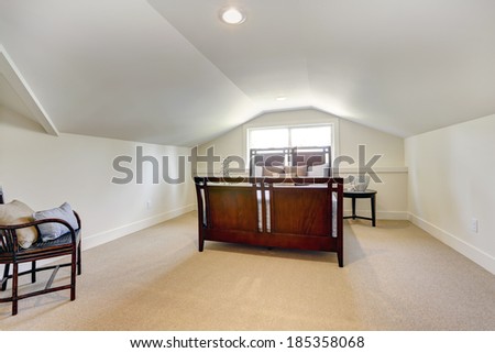 Bedroom with low vaulted ceiling. View of beautiful bedroom furniture set
