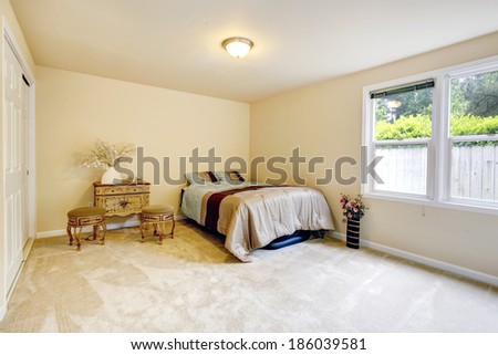 Gentle bedroom with single bed, antique cabinet and two chairs. Decorated with vases