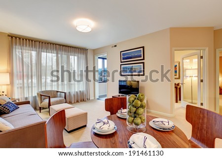 Open floor plan. Living room with dining area. View of served table