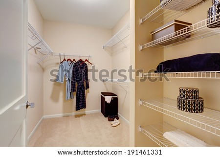 Light tones walk-in closet with shelves
