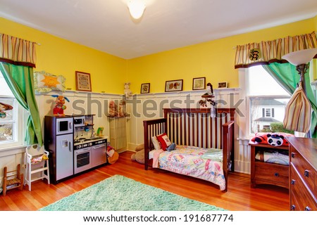 Bright yellow room for kids with toys