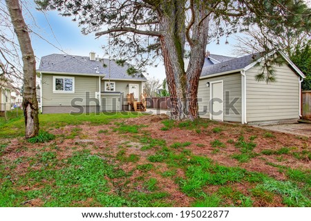 Backyard with trees and small shed. View of house exterior.