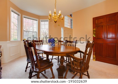 Soft colors dining room with carpet floor, rustic dining table set and cabinet