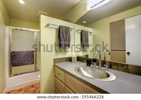 Bright bathroom with vanity, mirror and glass door shower