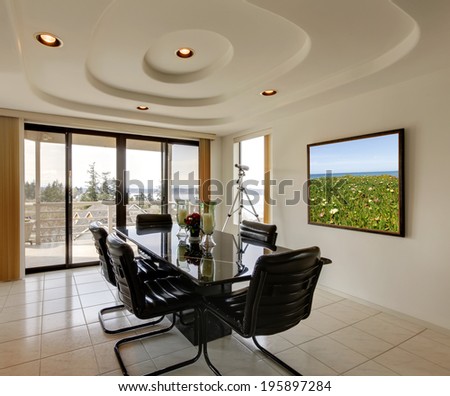 Elegant dining room with walkout deck and modern dining table set.