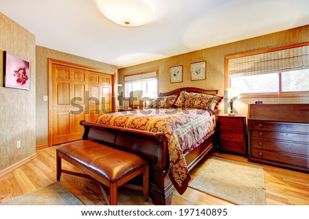 Rich bedroom with hardwood floor, closet and oak furniture set