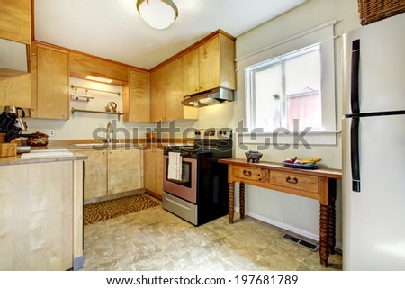 Small kitchen interior with modern appliances and antique cabinet with drawers