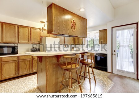 Bright kitchen room with  rustic bar stools, walkout deck