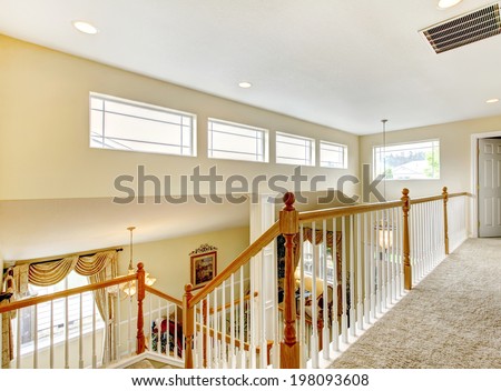Bright house with indoor balcony. View of living room and stairs