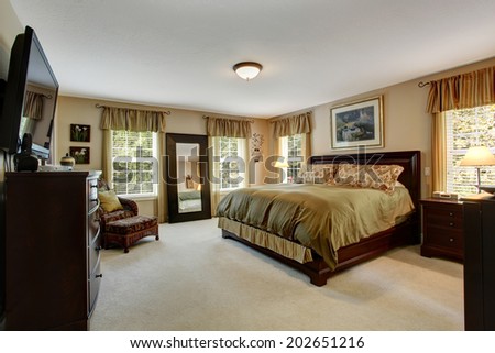 Cozy bedroom interior with carpet floor and wooden furniture set. Room in olive olive colors