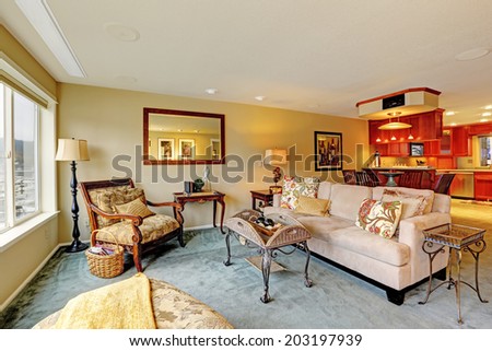 House with open floor plan. View of living room with antique furniture and table.