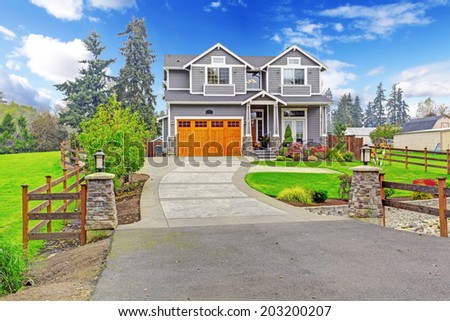 House exterior. Big house with column porch, garage and driveway view