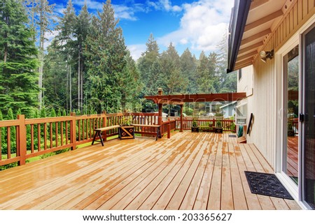 Spacious wooden deck with benches overlooking nature landscape