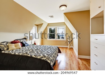 Elegant bedroom interior  in light ivory tone Furnished with bed in black and white bedding with pillows