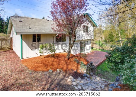 Spacious backyard with wooden floor walkout deck. View of landscape