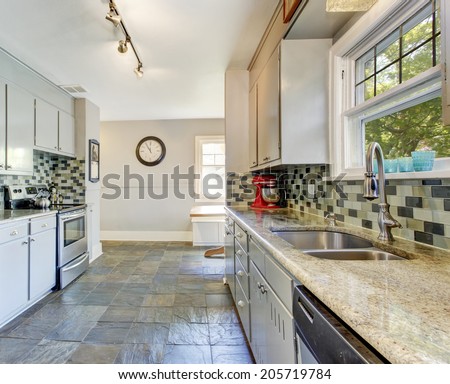 Kitchen room interior with tile back splash trim and tile floor